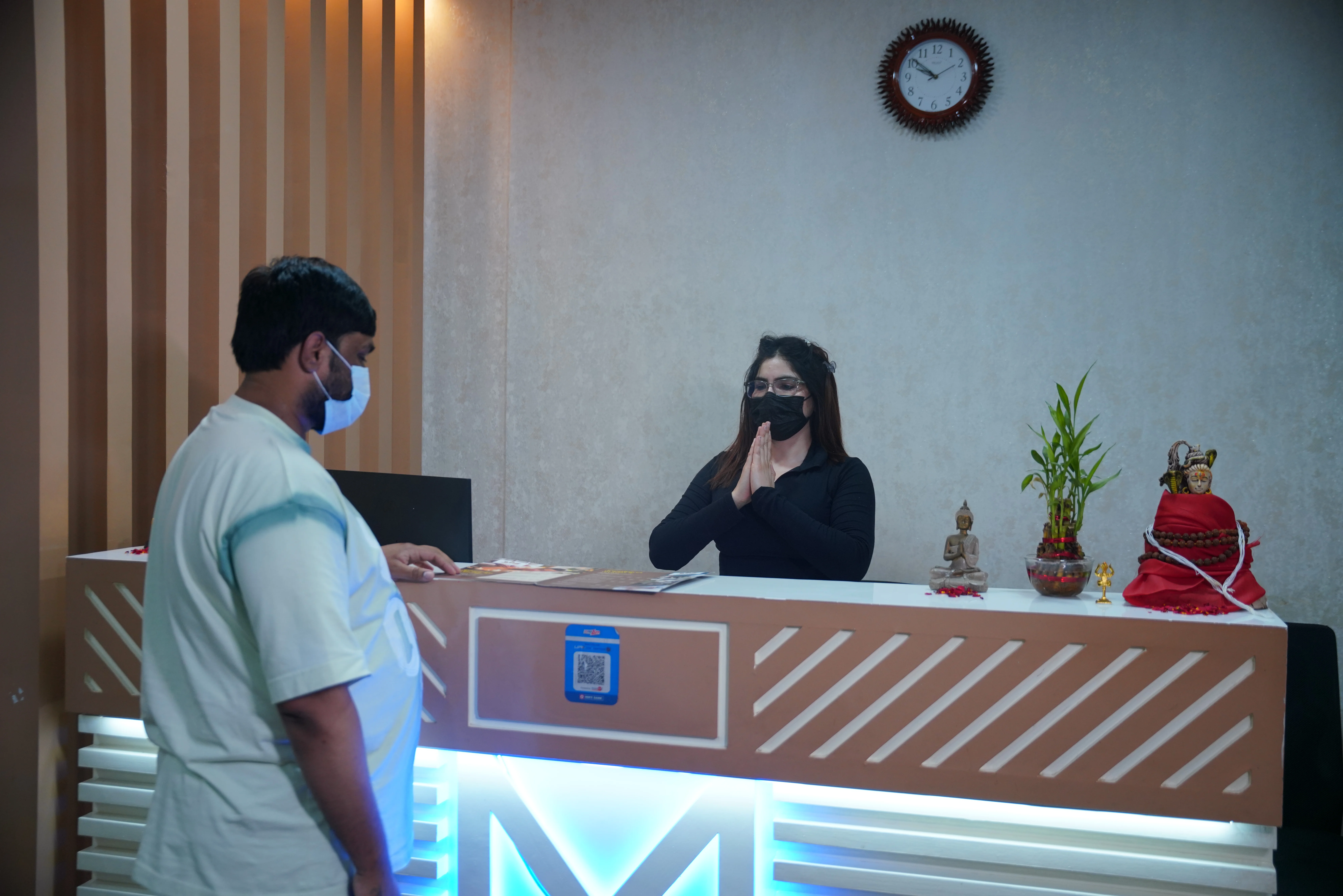 Receptionist welcoming guests with a Namaste at The Zen Spa & Lounge, Guntur